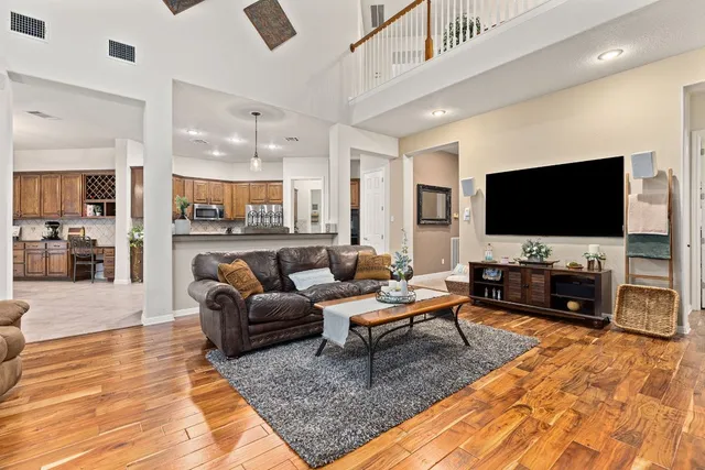 a living room with furniture and a flat screen tv