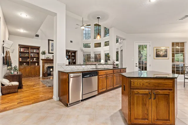 a kitchen with stainless steel appliances a refrigerator and a stove top oven