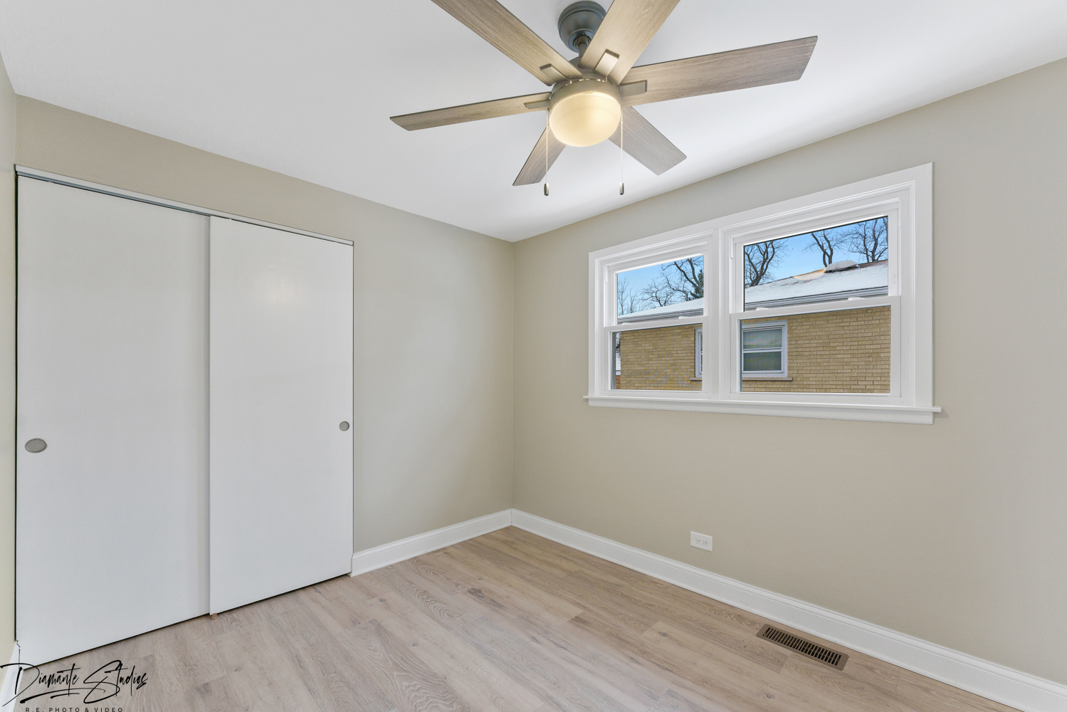 244 North Wolf Road Hillside, IL 60162 - Photo 6 of 12 a view of an empty room with window and wooden floor