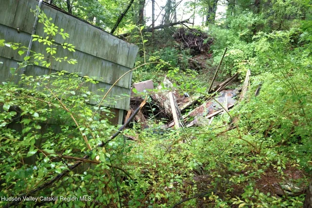 a backyard of a house with lots of green space and a fountain