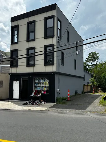 a front view of a house with a street