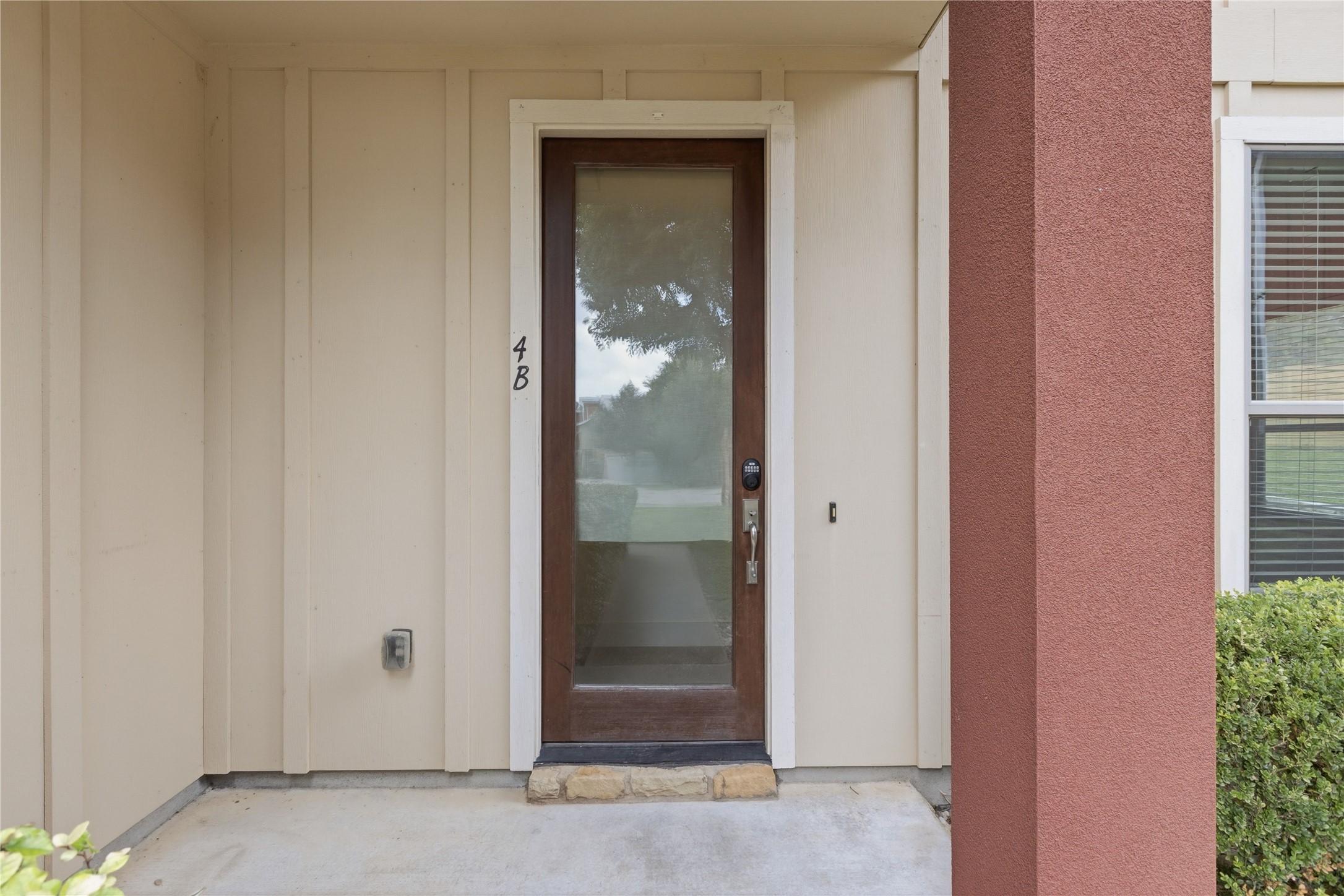 A refined glass-paneled entry door welcomes you to this sophisticated residence.