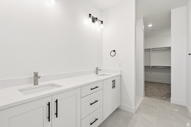 4978 North 75 East Enoch, UT 84721 - Photo 20 of 60 Bathroom with double vanity and a spacious closet