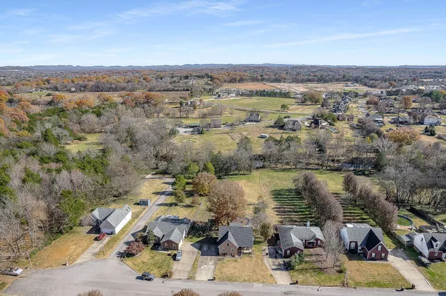 an aerial view of a house with a lake view