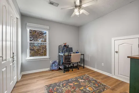 a view of a workspace with furniture and a window
