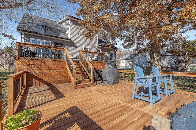 a view of a chair and tables on the roof deck