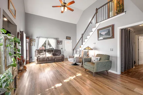 a living room with furniture and a chandelier