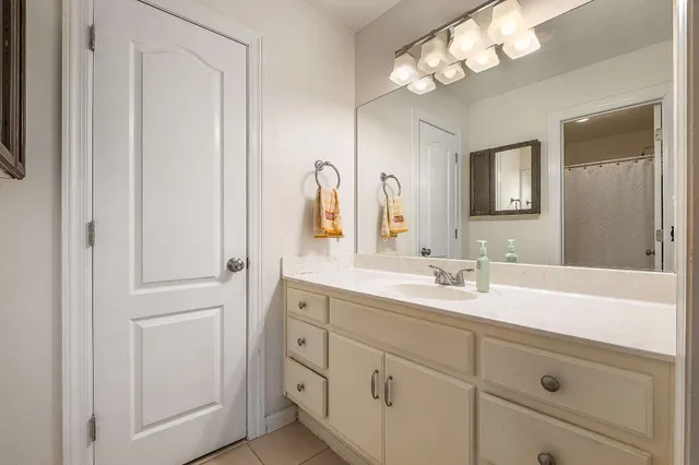 a bathroom with a sink a mirror and a light fixture