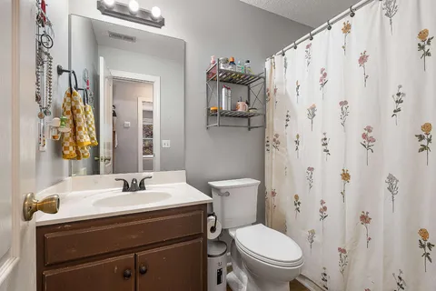 a bathroom with a sink toilet and mirror