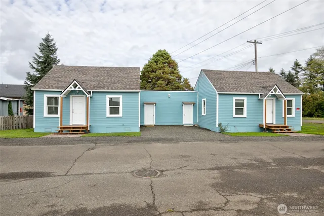 a front view of a house with a yard and a garage