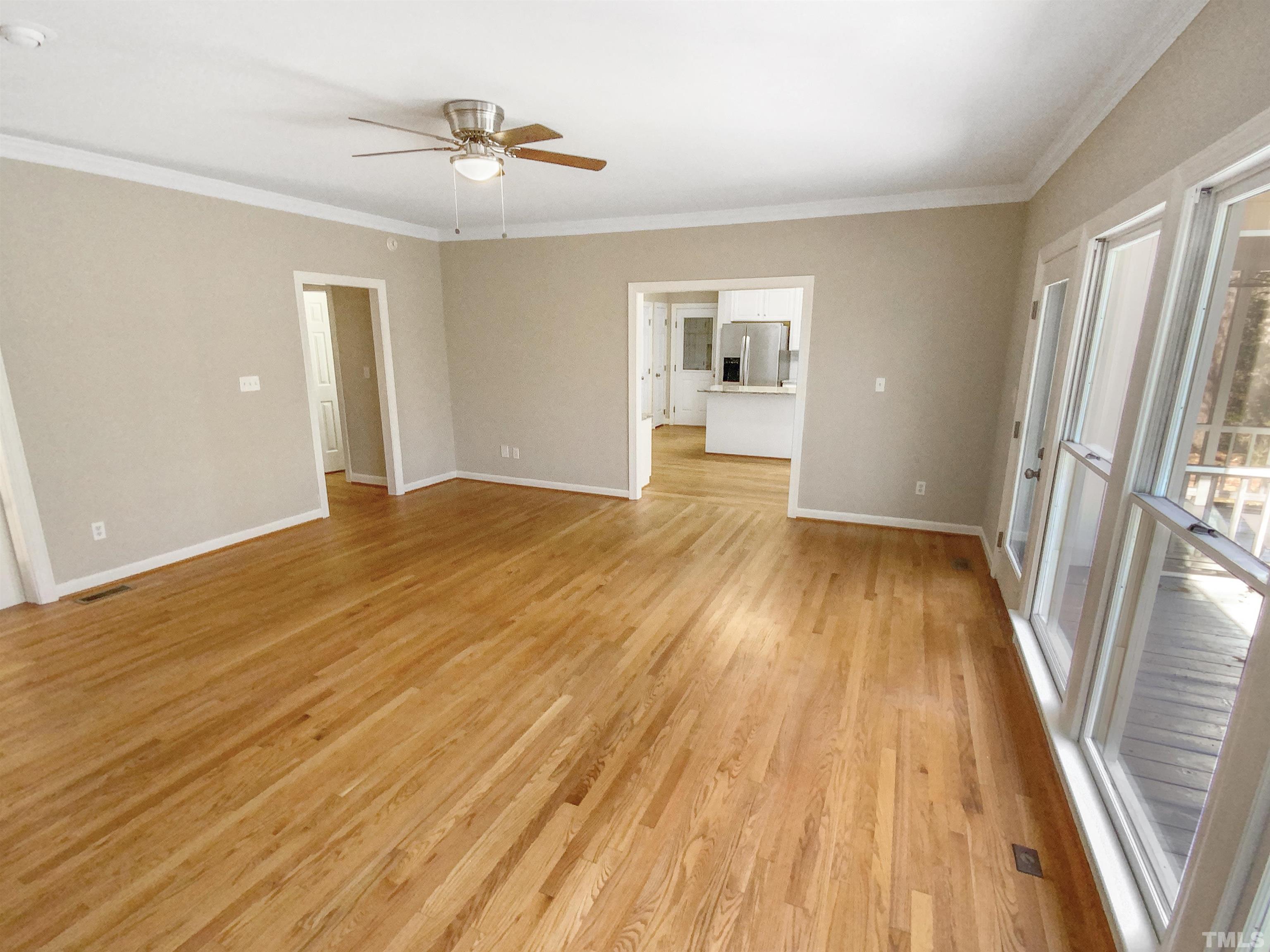 12020 Old Creedmoor Road Raleigh, NC 27613 - Photo 12 of 30 wooden floor in an empty room with a window
