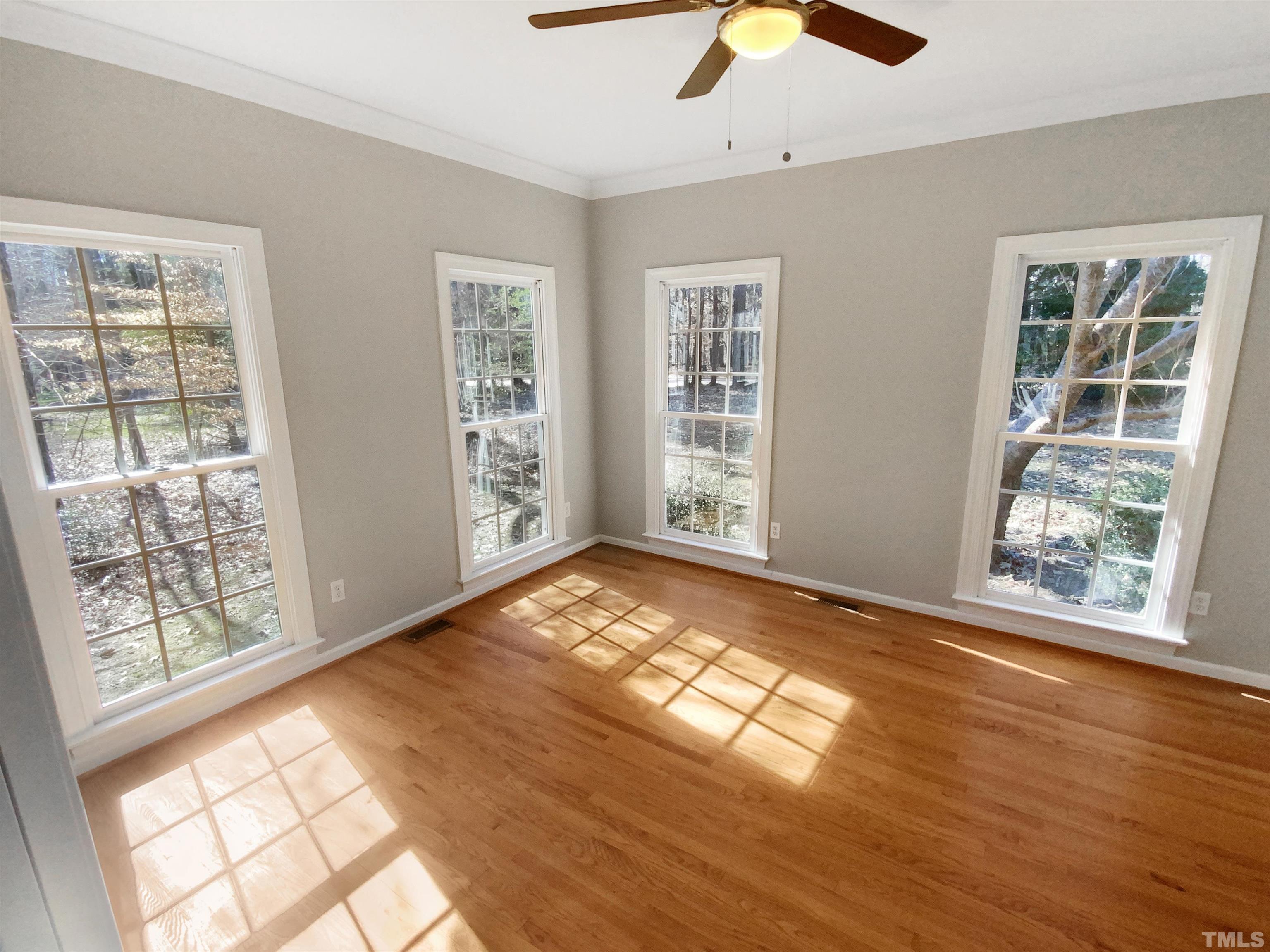 12020 Old Creedmoor Road Raleigh, NC 27613 - Photo 13 of 30 a view of an empty room with window and wooden floor