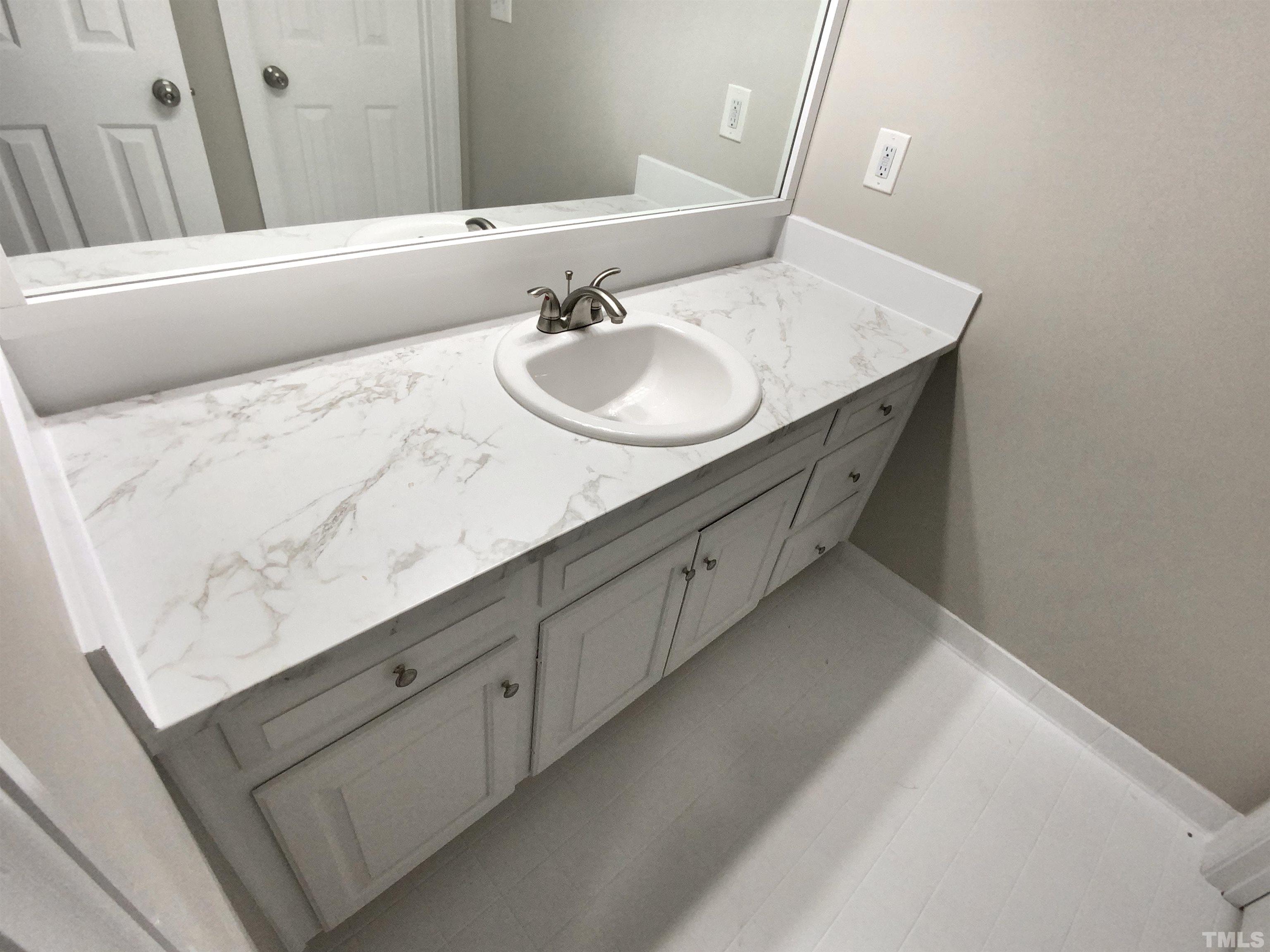 12020 Old Creedmoor Road Raleigh, NC 27613 - Photo 19 of 30 a bathroom with a sink and a mirror