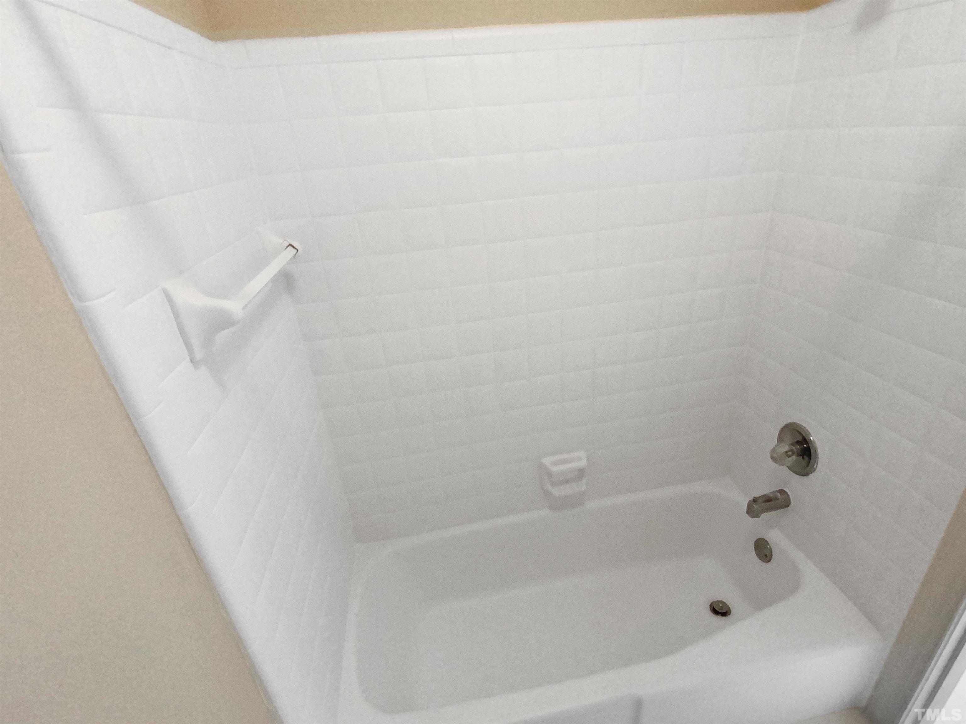 12020 Old Creedmoor Road Raleigh, NC 27613 - Photo 20 of 30 a bathroom with a bathtub
