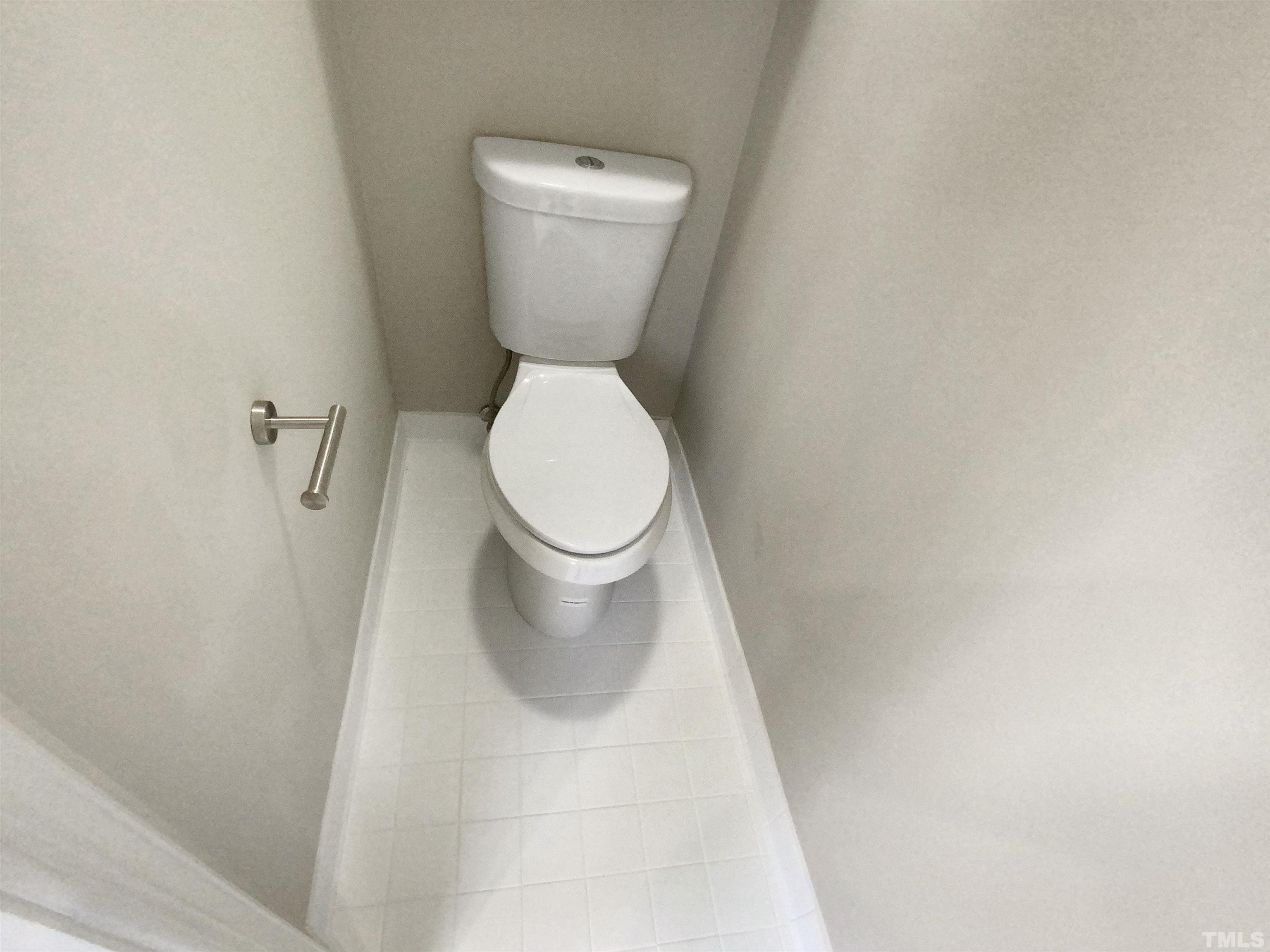 12020 Old Creedmoor Road Raleigh, NC 27613 - Photo 24 of 30 a white toilet sitting next to a white wall