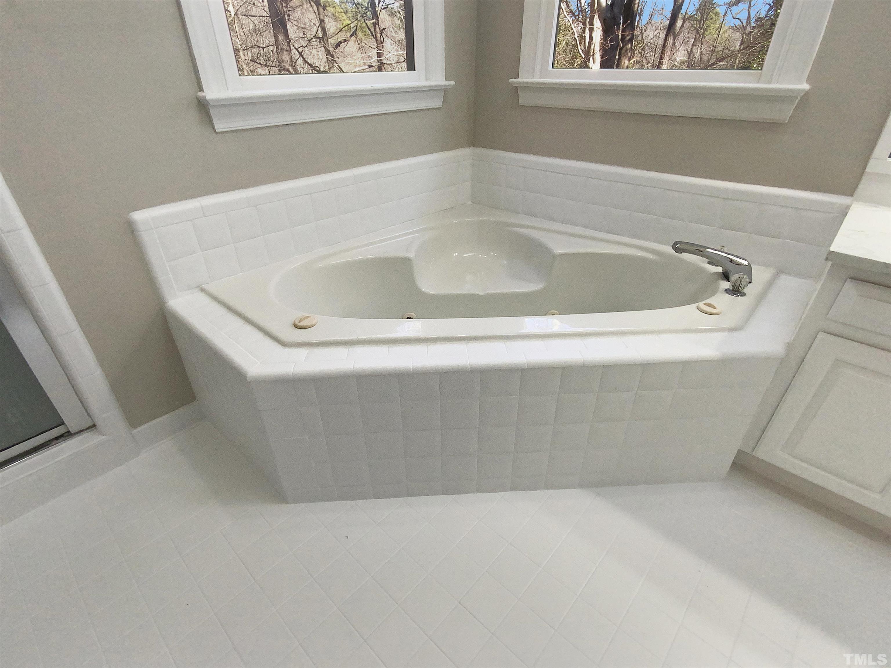 12020 Old Creedmoor Road Raleigh, NC 27613 - Photo 26 of 30 a white bath tub sitting in a bathroom