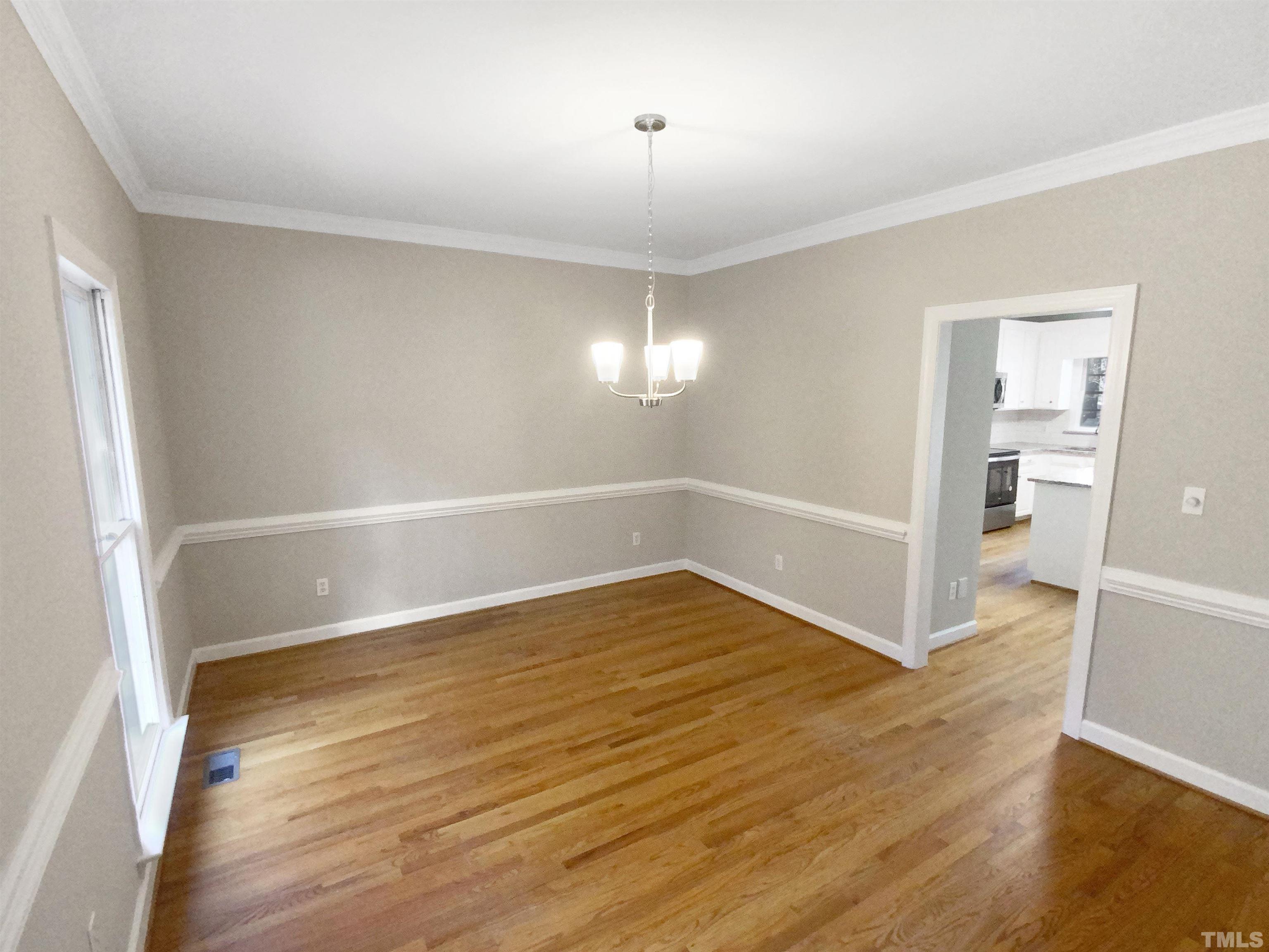 12020 Old Creedmoor Road Raleigh, NC 27613 - Photo 8 of 30 wooden floor in an empty room with a window