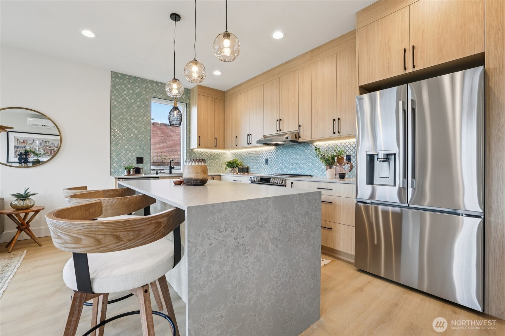 2628 58th Avenue Southwest Seattle, WA 98116 - Photo 11 of 40 a kitchen with stainless steel appliances granite countertop a sink refrigerator and cabinets