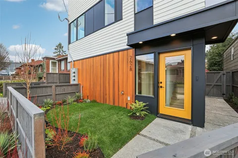 a view of a garden with a wooden fence
