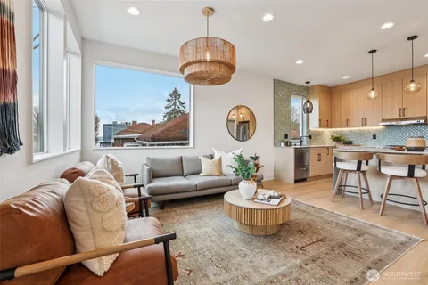 a living room with furniture and a chandelier