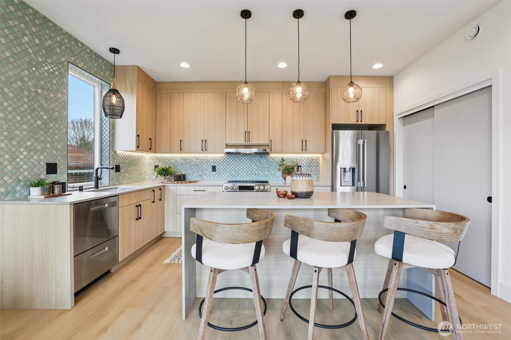 2628 58th Avenue Southwest Seattle, WA 98116 - Photo 10 of 40 a kitchen with a dining table chairs stainless steel appliances and cabinets