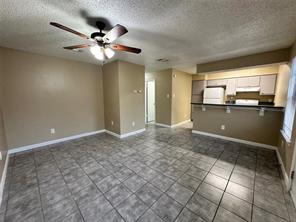 4607 East 12th Street, Unit 1 Austin, TX 78721 - Photo 1 of 9 Unfurnished living room with a textured ceiling and a ceiling fan