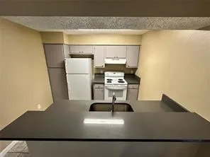 a kitchen with a refrigerator and a stove