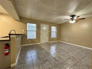 4607 East 12th Street, Unit 1 Austin, TX 78721 - Photo 9 of 9 Foyer entrance with a textured ceiling, tile patterned flooring, and ceiling fan