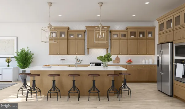 a kitchen with stainless steel appliances kitchen island granite countertop a table chairs sink and cabinets