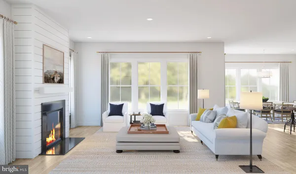 a living room with furniture large window and fireplace