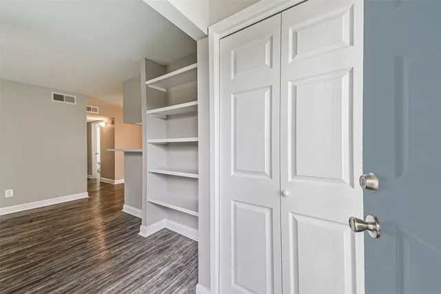a view of a room with wooden floor