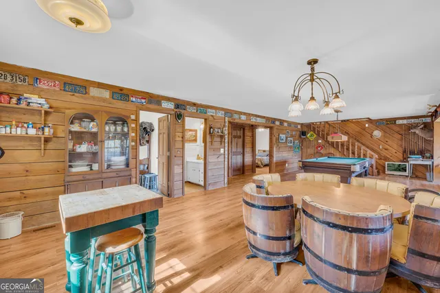 a living room with patio furniture and a floor to ceiling window