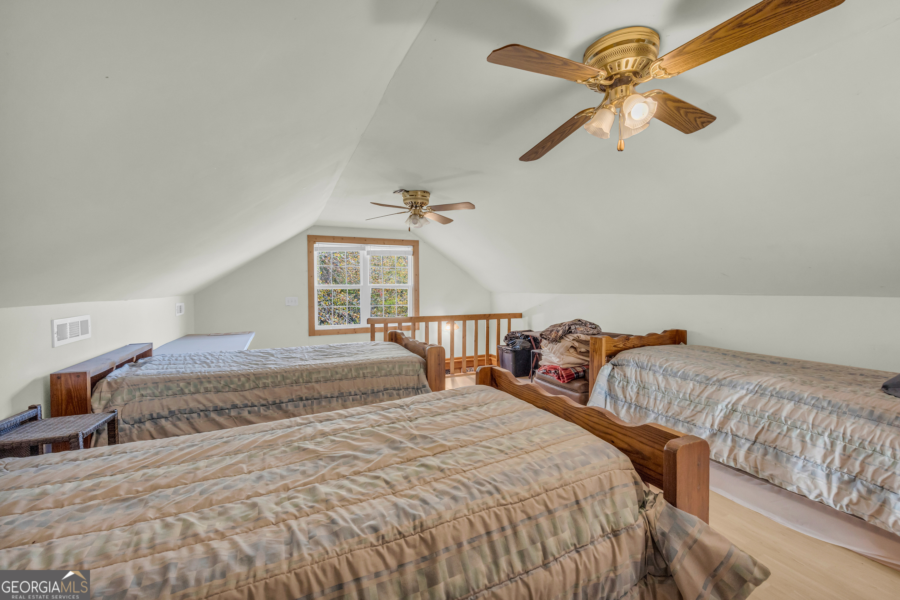 23824 Highway 22 Sparta, GA 31087 - Photo 45 of 94 a bedroom with two beds and a chandelier