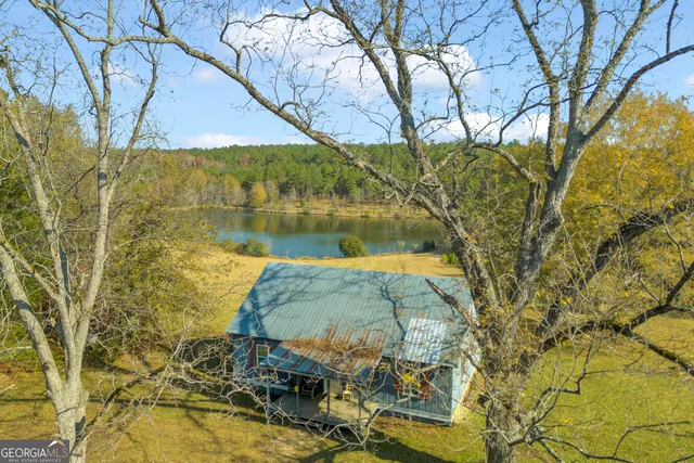 a living room with couches and dining table with wooden floor