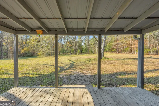 a room with pool table and wooden floor
