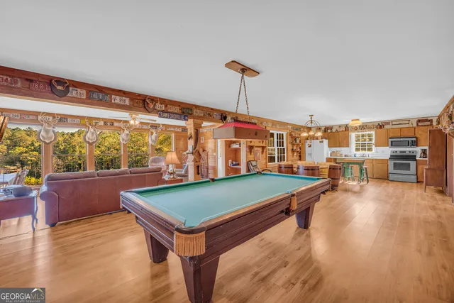 a living room with stainless steel appliances kitchen island granite countertop furniture and a kitchen view