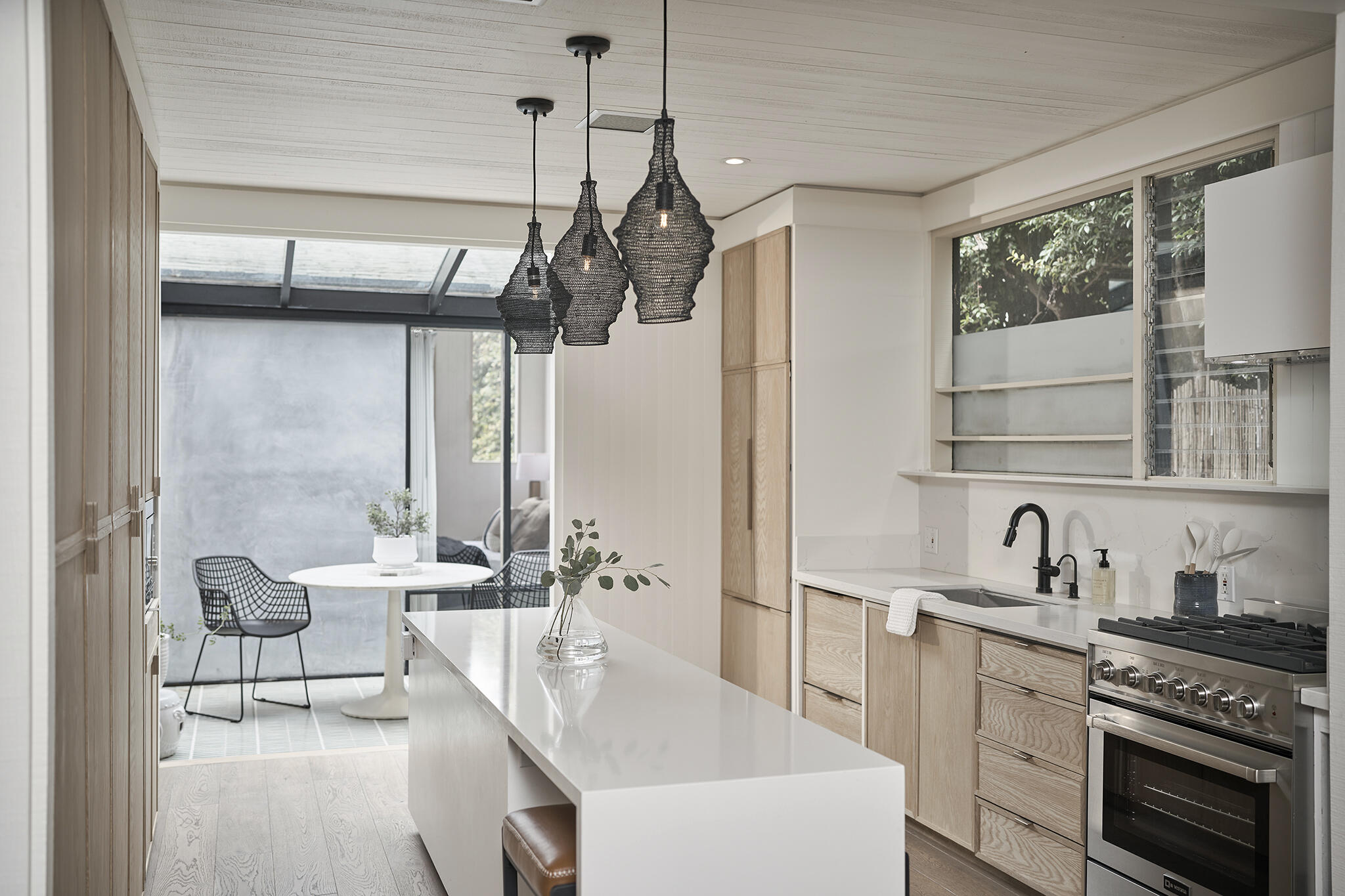 180 Hermosillo Road Montecito, CA 93108 - Photo 14 of 56 a kitchen with stainless steel appliances a sink a stove and white cabinets next to a window