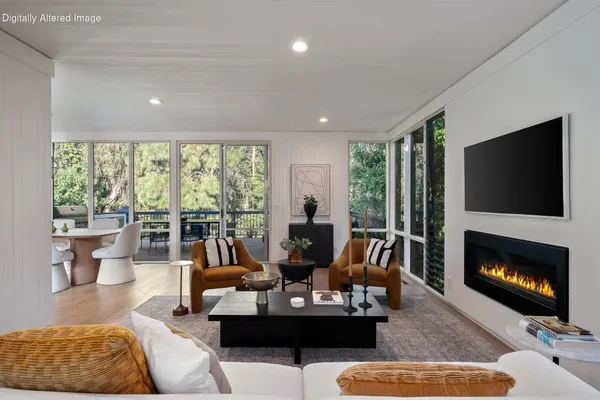 a dining room with furniture a chandelier and window