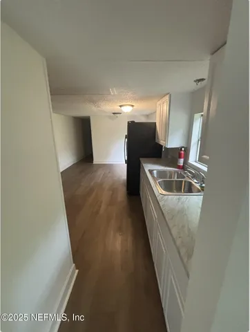 a view of a kitchen from the hallway