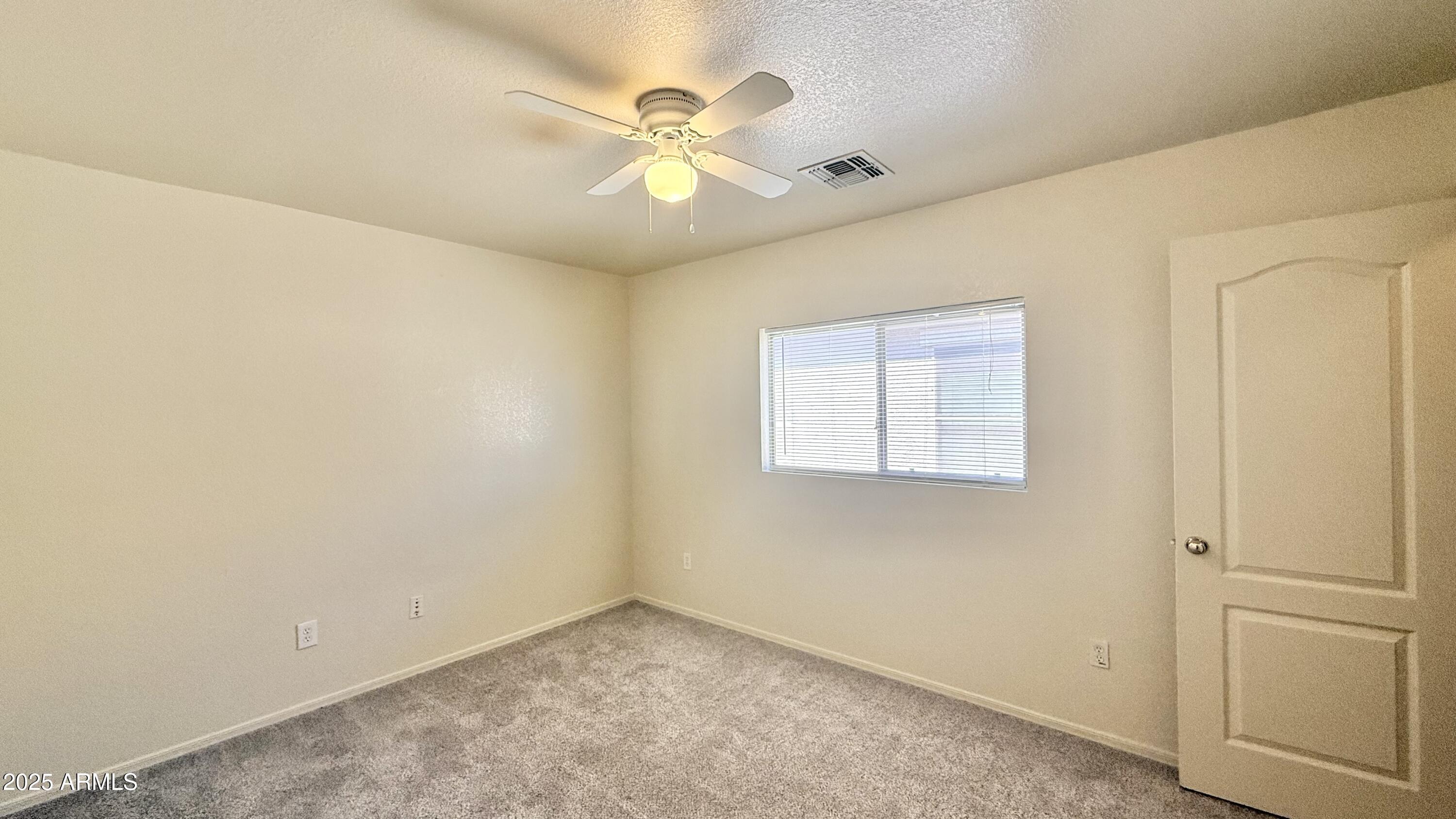 2499 South Marble Street Gilbert, AZ 85295 - Photo 11 of 21 an empty room with a window and ceiling fan