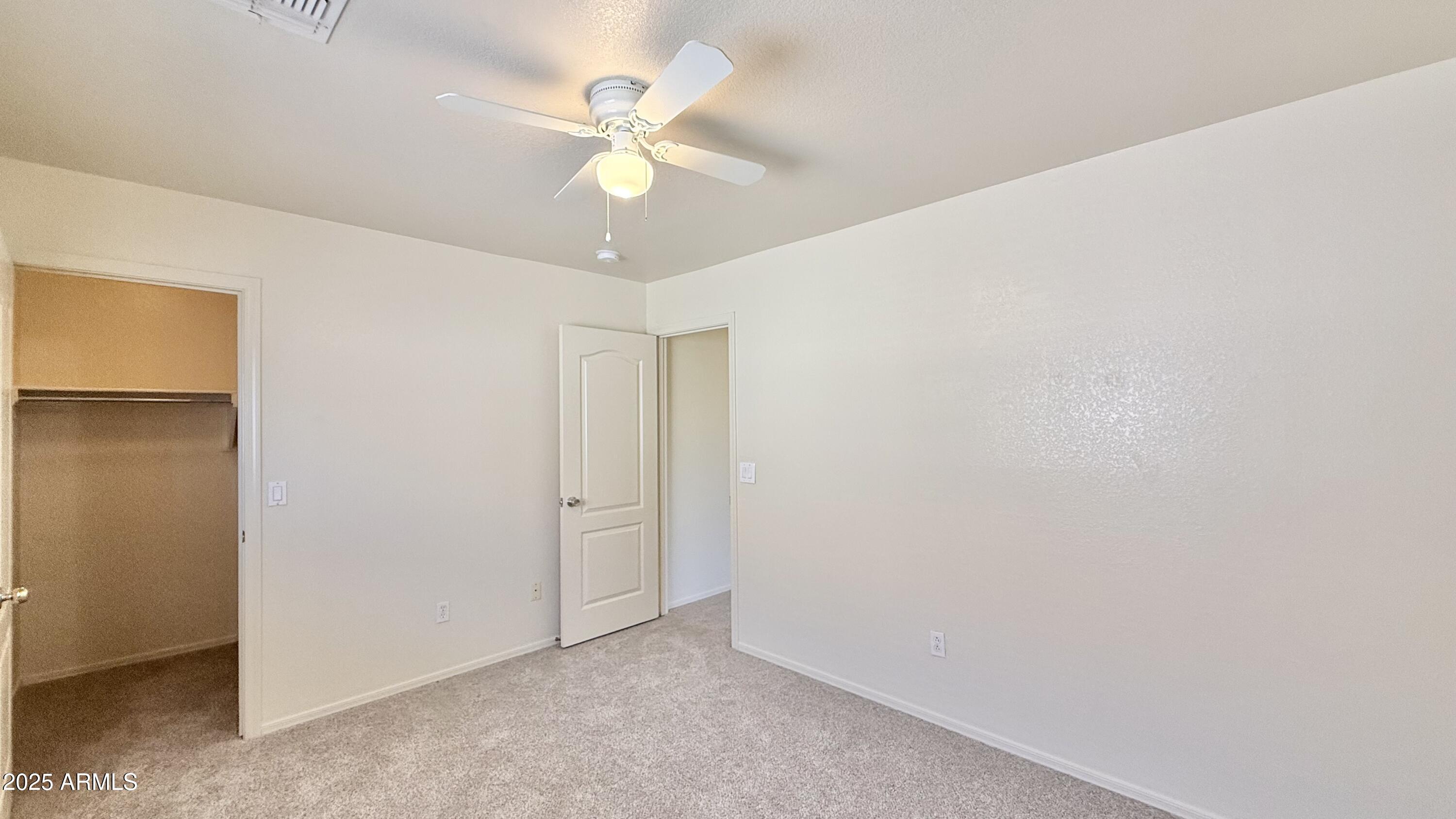2499 South Marble Street Gilbert, AZ 85295 - Photo 12 of 21 an empty room with a ceiling fan and a window