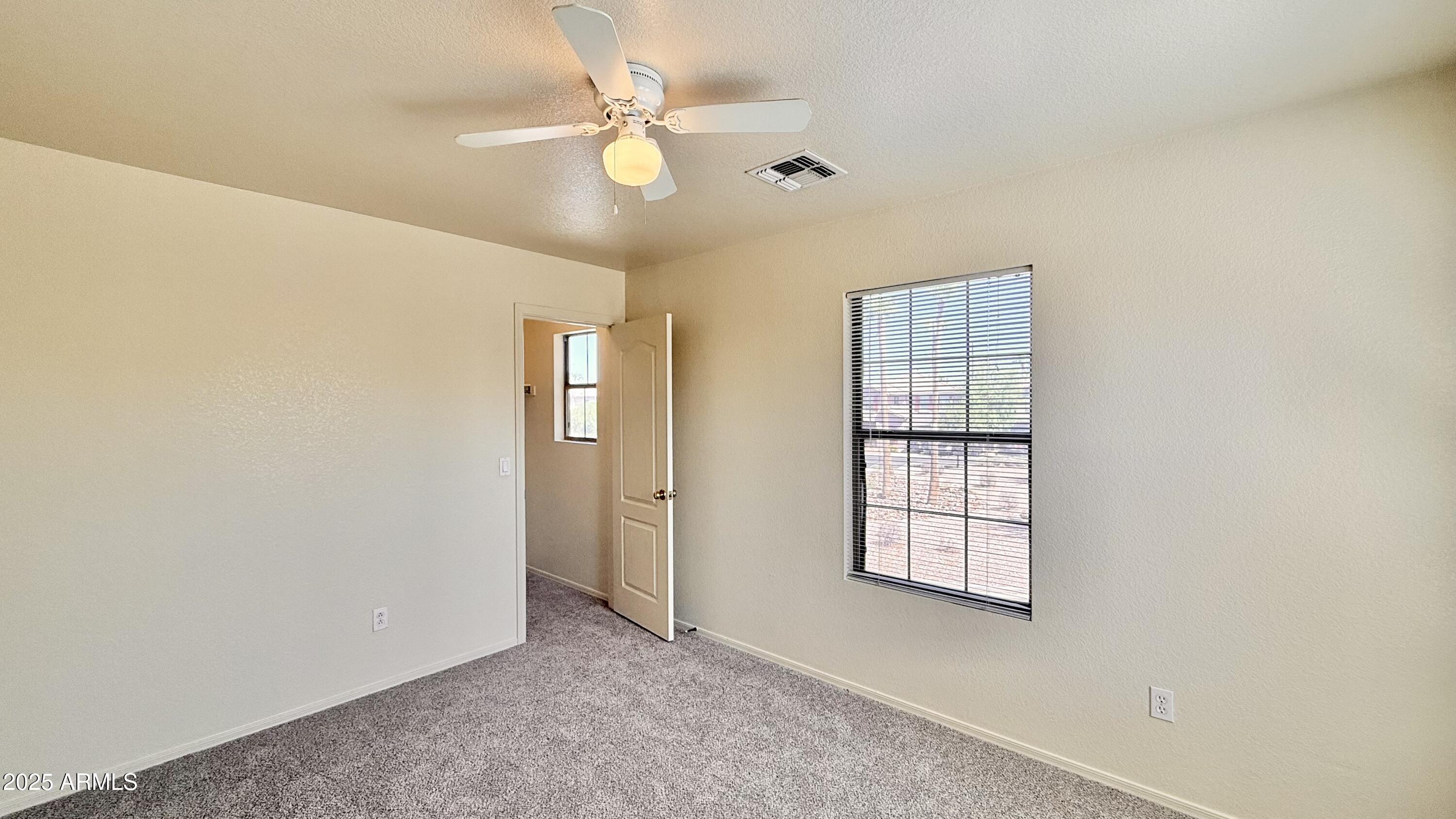 2499 South Marble Street Gilbert, AZ 85295 - Photo 14 of 21 an empty room with windows and fan