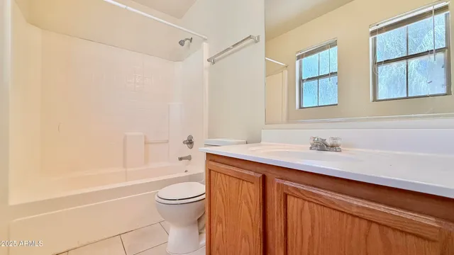 a bathroom with a granite countertop sink a toilet and shower