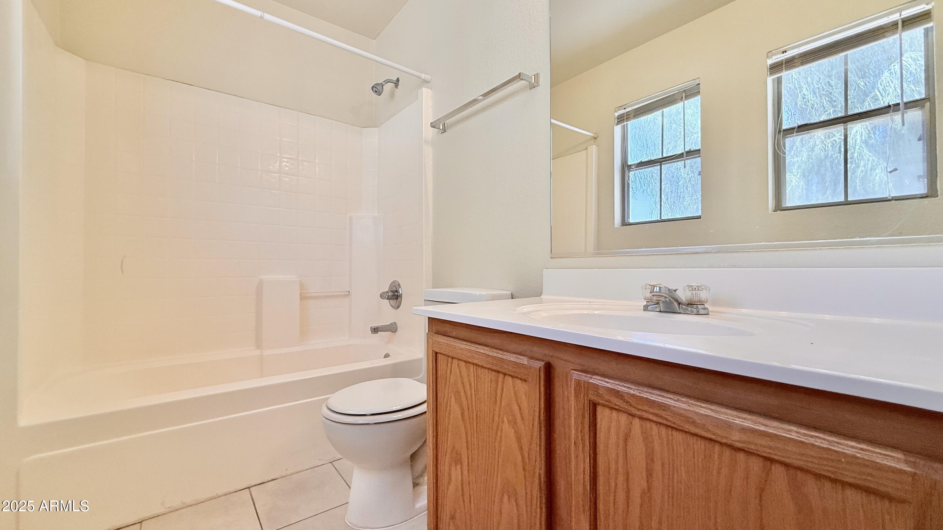 2499 South Marble Street Gilbert, AZ 85295 - Photo 16 of 21 a bathroom with a granite countertop sink a toilet and shower