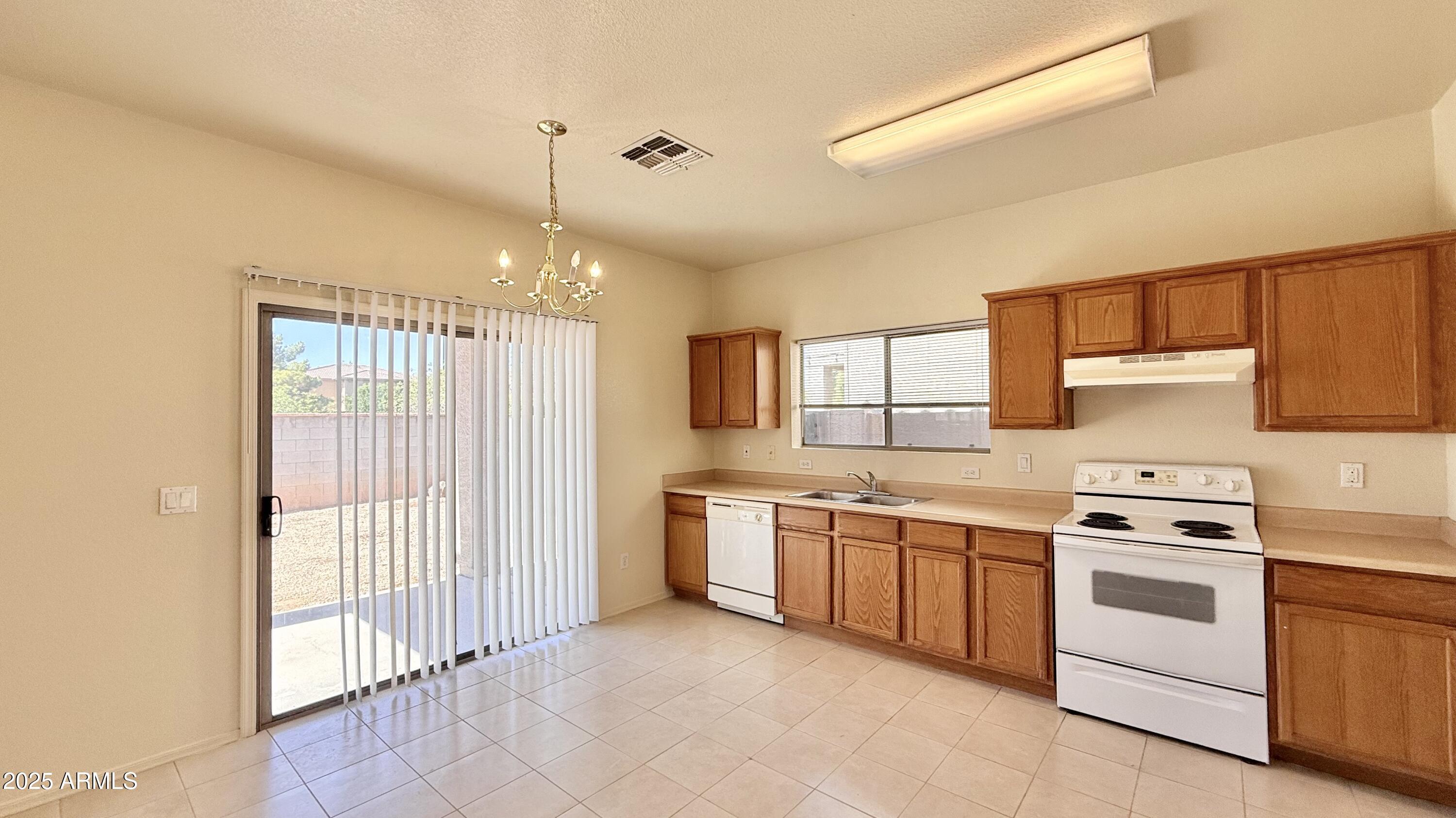 2499 South Marble Street Gilbert, AZ 85295 - Photo 2 of 21 a kitchen with white cabinets and white appliances