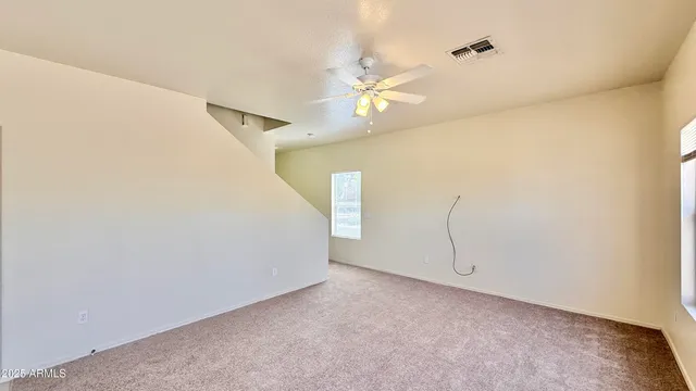 a view of a room with window and ceiling fan
