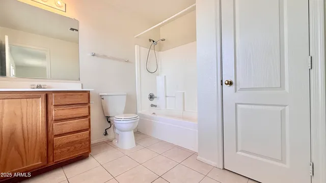 a bathroom with a granite countertop sink a toilet and shower