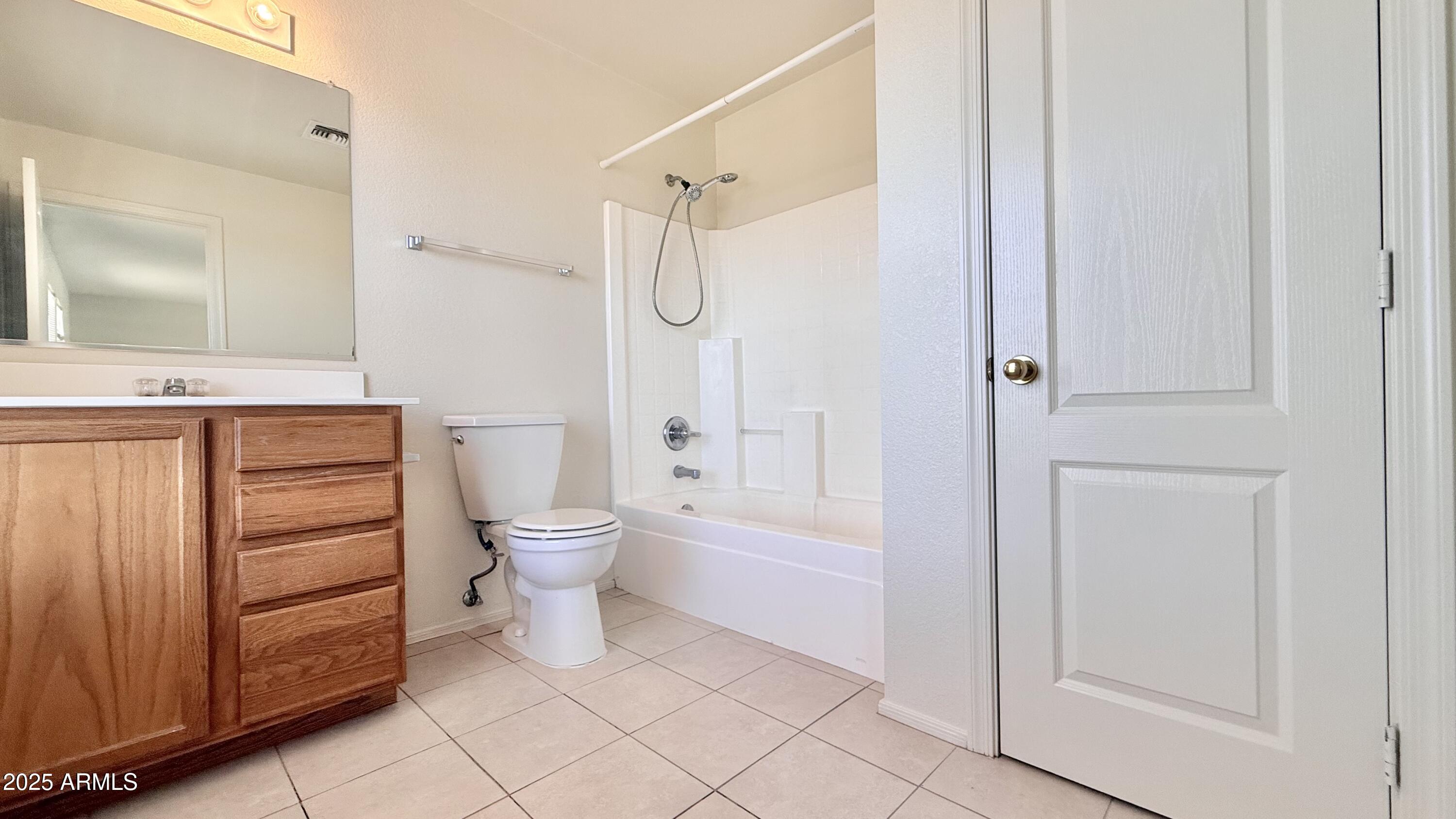 2499 South Marble Street Gilbert, AZ 85295 - Photo 10 of 21 a bathroom with a granite countertop sink a toilet and shower