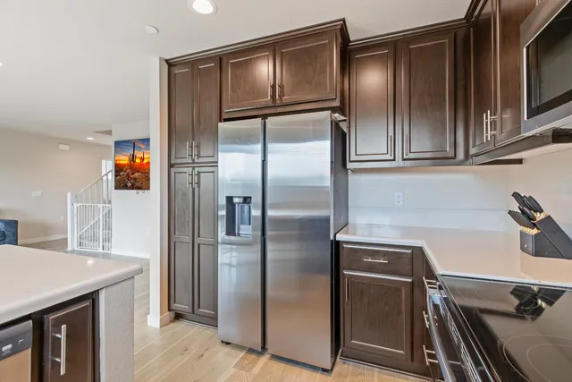 a kitchen with stainless steel appliances a refrigerator and a sink