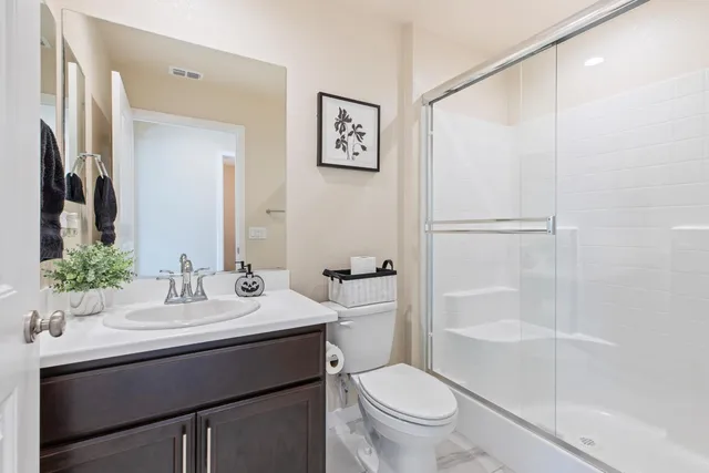 a bathroom with a sink toilet and shower